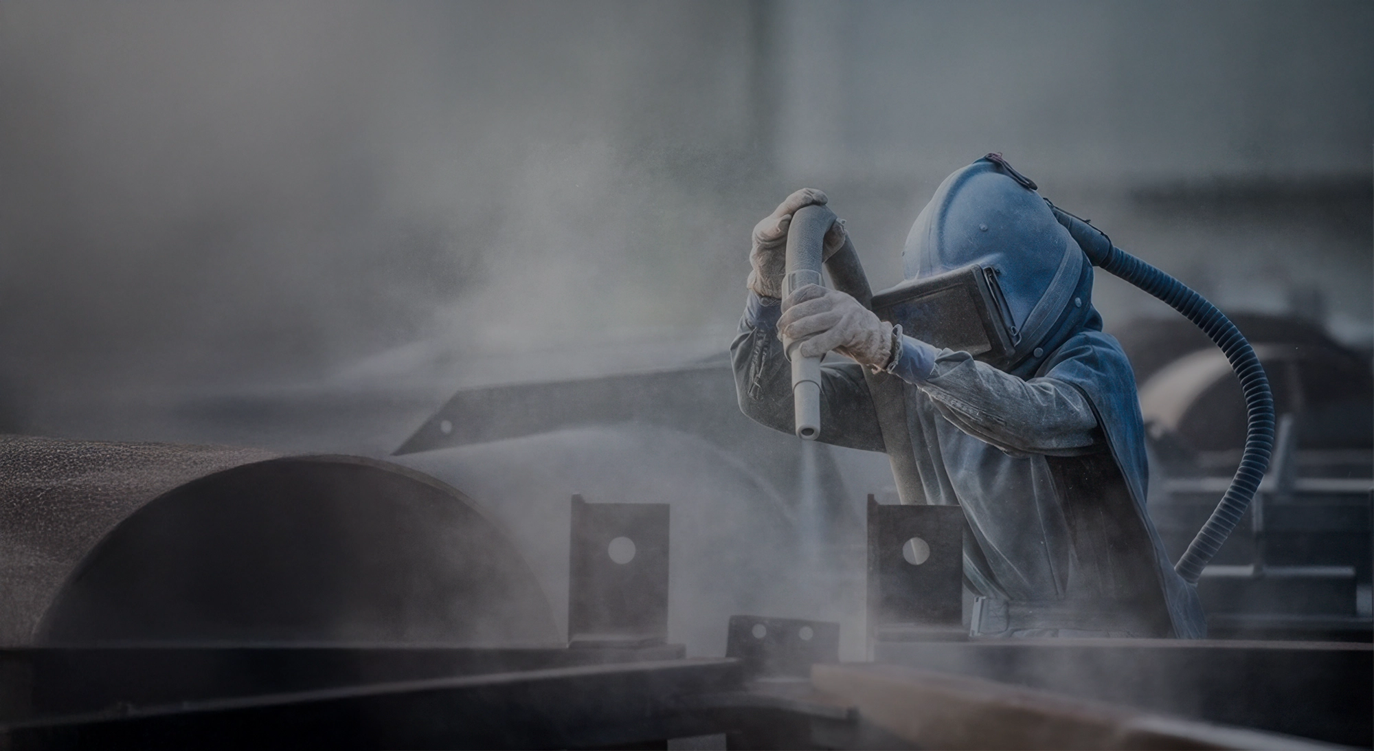 PBC operator in a full blast suit sandblasting structural steel in Melbourne
